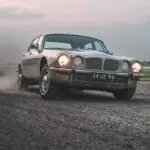The Jaguar XJ6 driving over the dirt