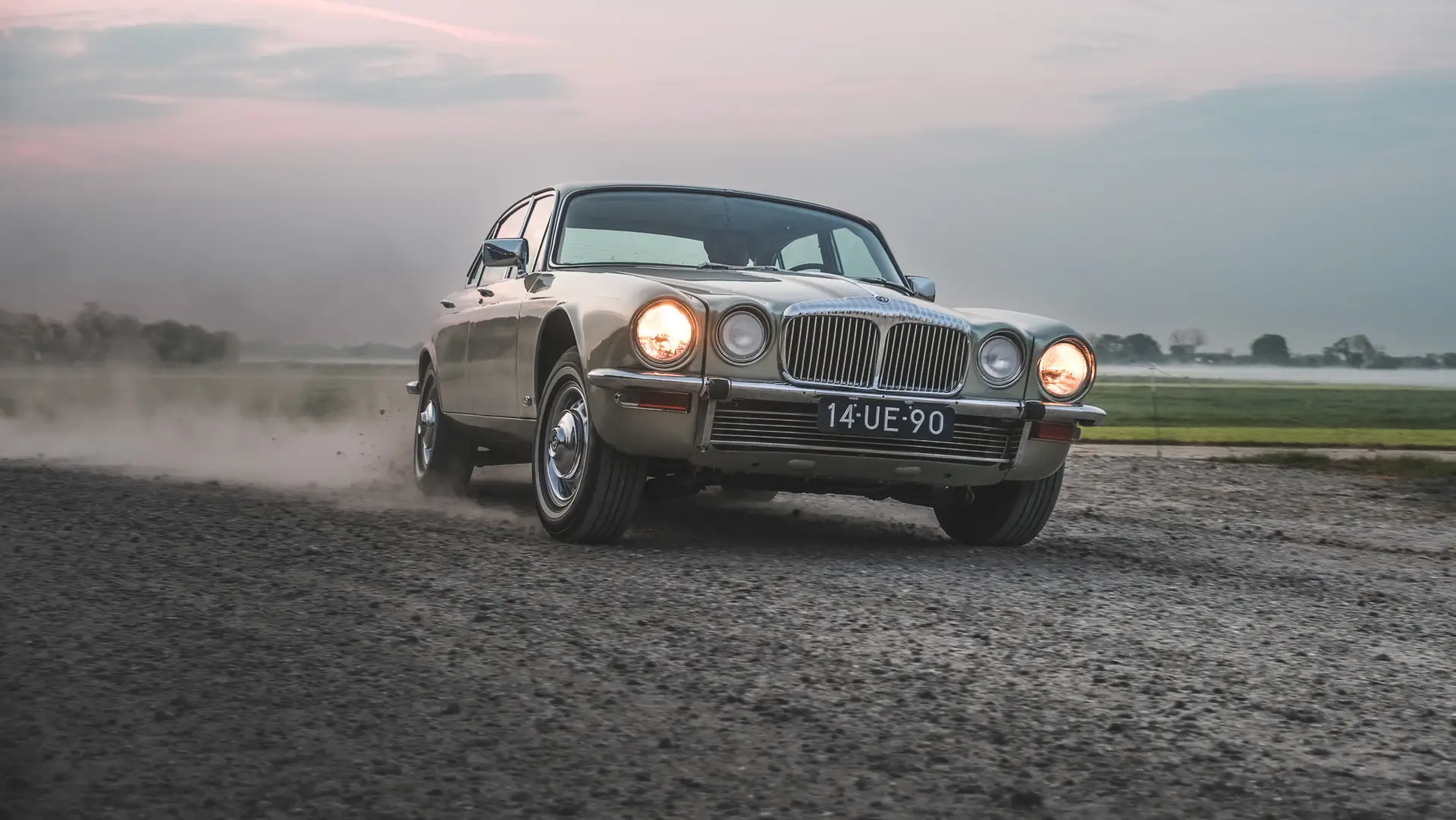The Jaguar XJ6 driving over the dirt
