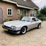 The Jaguar XJS V12 standing on the porch with numberplate JJ-RZ-55