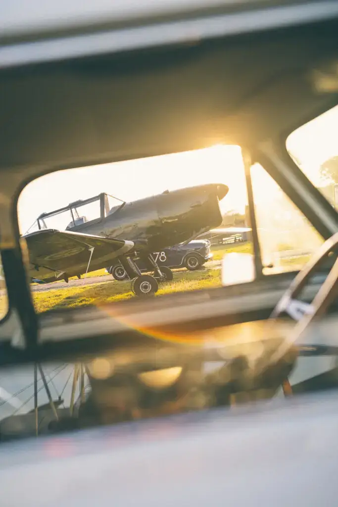 DHC-1 chipmunk seen through the window of a mini classic at evening sun