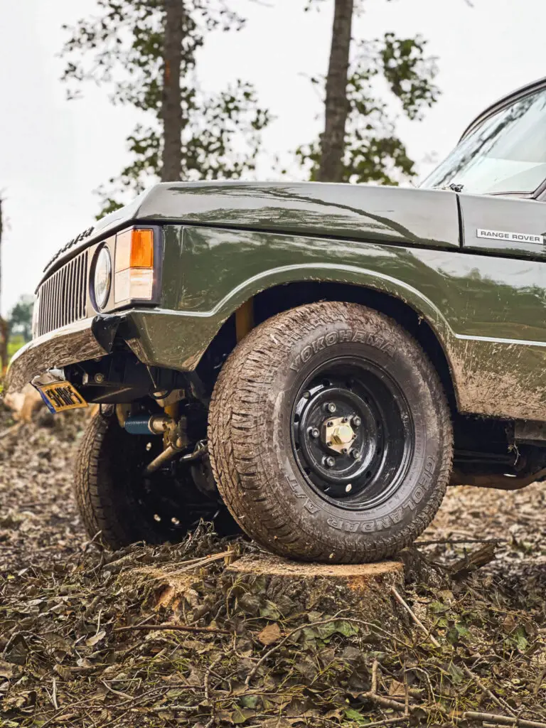 land rover range rover with yokohama tyres standing on a tree in offroad course brooks motors