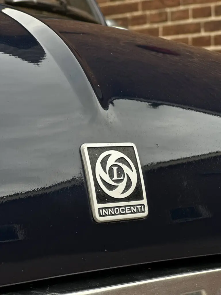 innocenti mini leyland badge on top of the bonnet of a mini classic