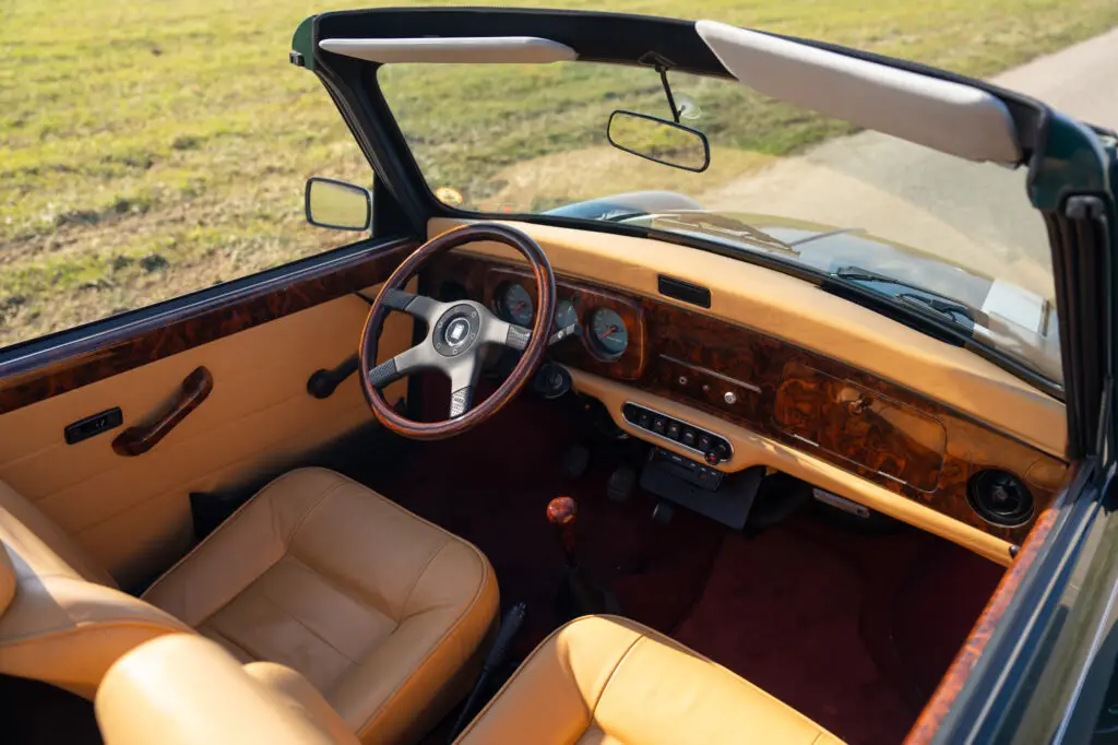 british racing green with light brown interior finished with a wooden dashboard and NARDI steering wheel