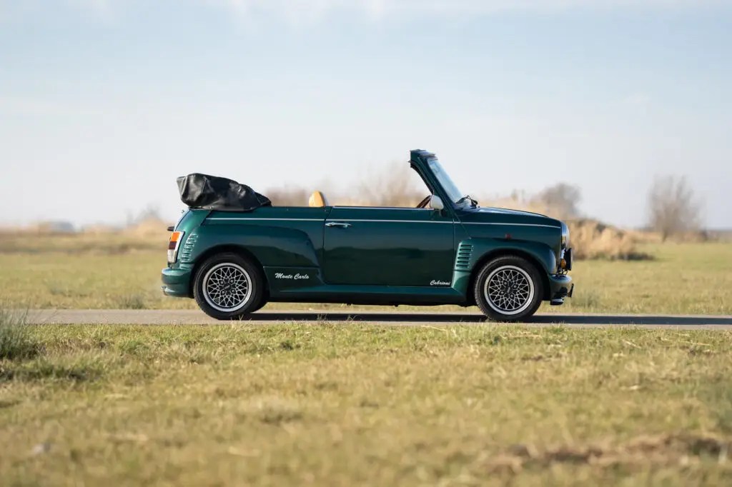 Mini classic Cabrioni 1.3 SPi cabrio in british racing green with silver EXIP rims side view. picture made in the biesbosch